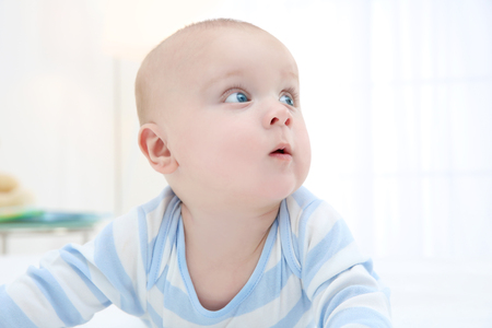 Portrait of cute baby boy at homeの写真素材