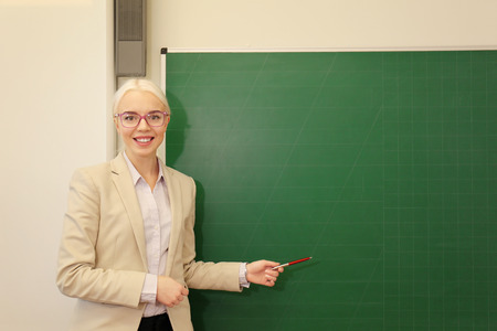 Beautiful school teacher in the classroomの写真素材