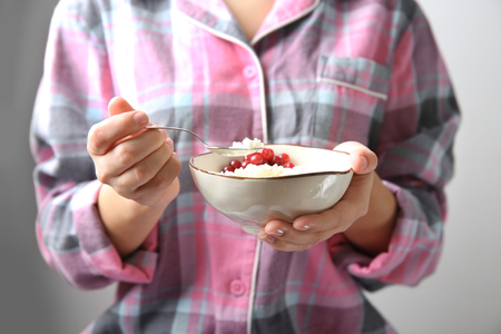 Closeup of woman holding bowl with healthy breakfastの写真素材