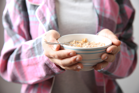 Closeup of woman holding bowl with healthy breakfastの写真素材