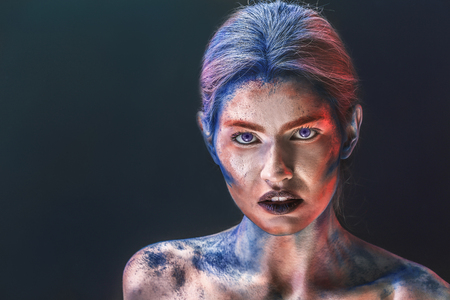 Portrait of beautiful young woman with amazing body-art on dark backgroundの写真素材