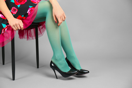 Woman wearing stockings and  high heels on color backgroundの写真素材