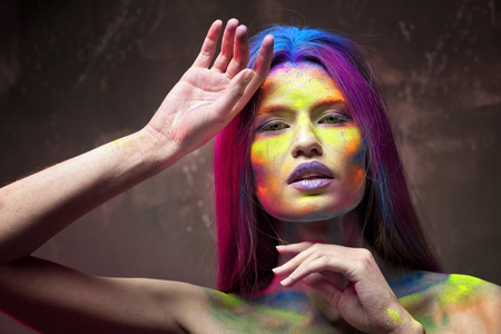 Portrait of beautiful young woman with amazing body-art on grey textured backgroundの写真素材