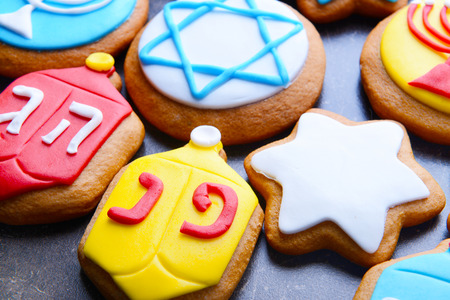 Tasty glazed cookies for Hanukkah on dark background, closeupの写真素材