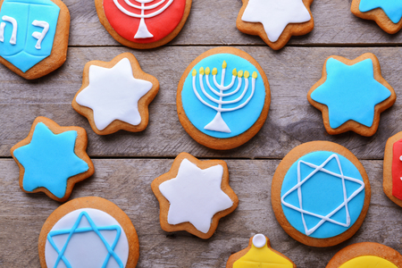 Tasty glazed cookies for Hanukkah on wooden table, closeupの写真素材