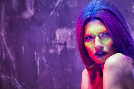 Portrait of beautiful young woman with amazing body-art on color backgroundの写真素材