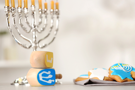 Beautiful composition for Hanukkah on grey table against blurred backgroundの写真素材