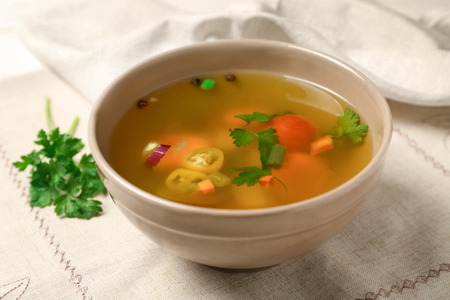 Bowl with fresh vegetable soup on napkinの写真素材