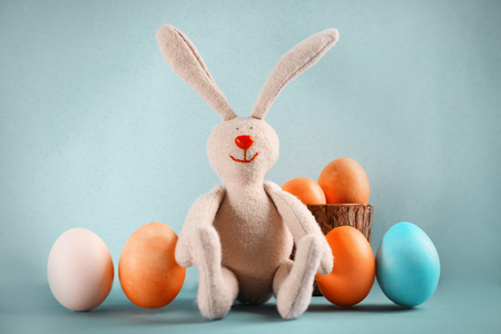 Easter bunny with eggs on color backgroundの写真素材