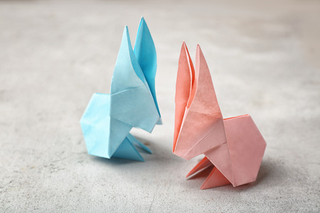 Origami paper bunnies on light backgroundの写真素材