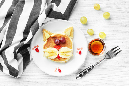 Plate with creative homemade pancake on wooden tableの写真素材