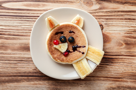 Plate with creative homemade pancake on wooden tableの写真素材