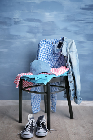 Pile of clothes on wooden chairの写真素材