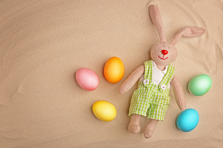 Easter eggs with bunny on sandの写真素材
