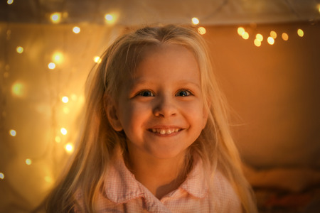 Portrait of cute smiling girl on blurred backgroundの写真素材