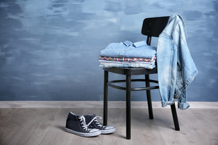 Pile of clothes on wooden chair