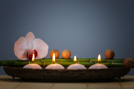 Spa composition with candles on color backgroundの写真素材