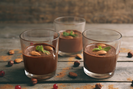 Chocolate mousse in glasses on wooden backgroundの写真素材