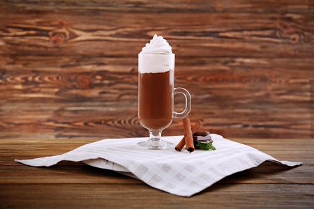 Chocolate mousse in glass with cinnamon sticks  on wooden backgroundの写真素材