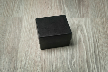 Black cardboard box on wooden backgroundの写真素材