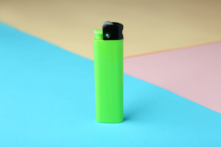 Blank cigarette lighter on color paper backgroundの写真素材