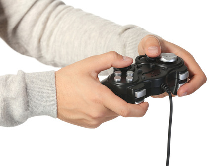 Hands of teenager with game controller on white background, closeup