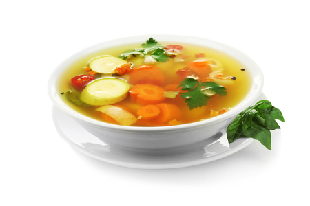 Bowl with vegetable soup on white backgroundの写真素材