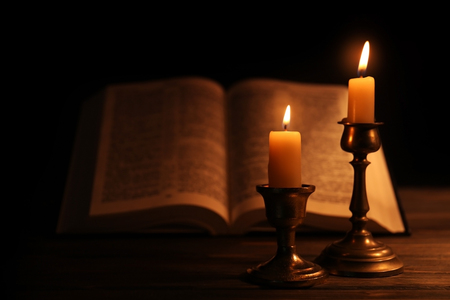 Burning candles and Bible on backgroundの写真素材
