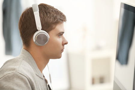 Teenager playing computer game at homeの写真素材
