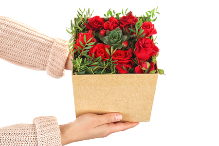 Woman holding beautiful flowers in gift box on white backgroundの写真素材