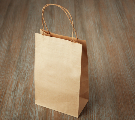 Blank paper bag on wooden backgroundの写真素材