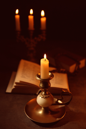Burning candle with  Bible on backgroundの写真素材