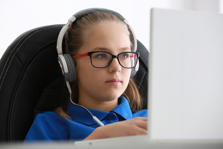 Pretty teenager playing computer game at home