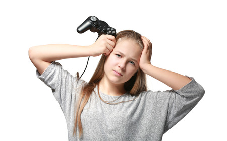 Pretty teenager with game controller on white background
