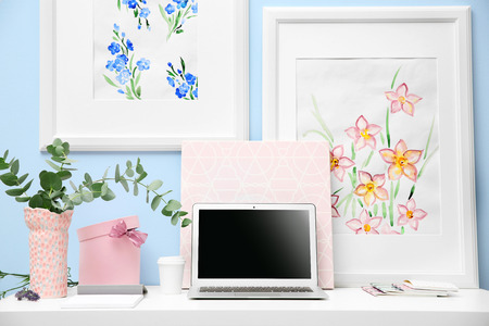Workplace with laptop on desk in modern roomの写真素材