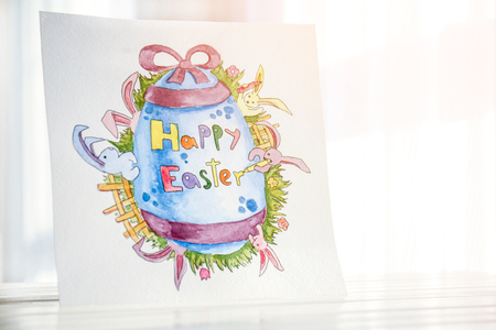 Beautiful Easter greeting card on wooden surfaceの写真素材