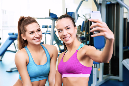 Young women taking selfie in gymの写真素材