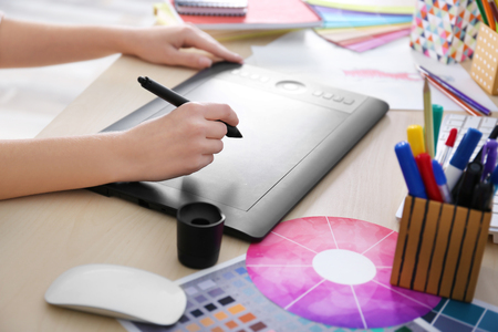 Designer workplace. Woman using graphic tablet, closeupの写真素材
