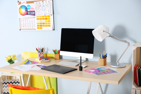 Modern designer workplace with computer and stationeryの写真素材