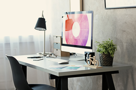 Workplace with computer on table in modern roomの写真素材