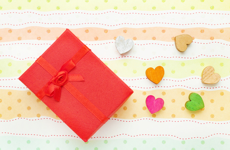 Gift box and decorative hearts on colorful backgroundの写真素材