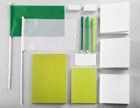 Flat lay of blank green and white goods on tableの写真素材