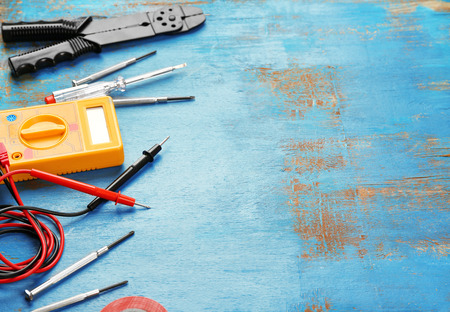 Different electrical tools on wooden table