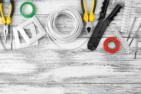 Different electrical tools on wooden table