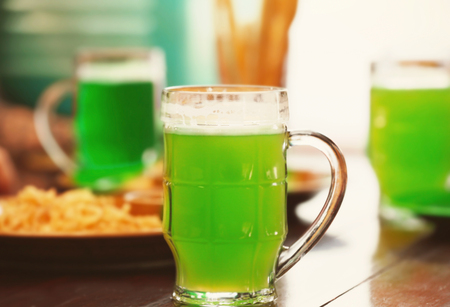 Mug with cold beer on table in pubの写真素材