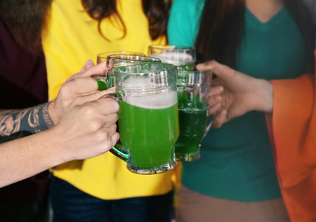 Friends with beer celebrating Saint Patrick's Day in pub, closeupの写真素材