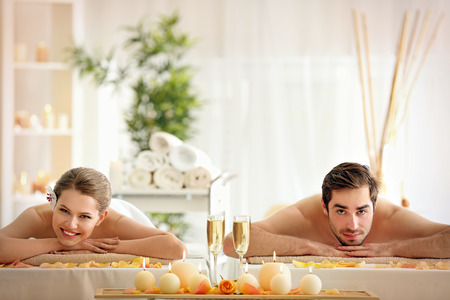 Young happy couple relaxing in spa salon