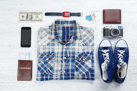 Flat lay of traveller's accessories on wooden backgroundの写真素材