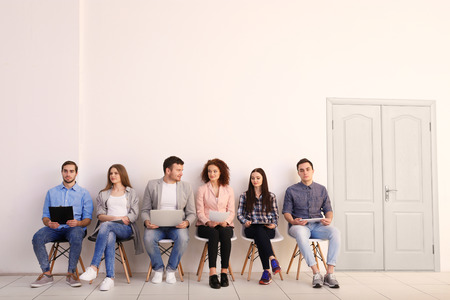 Group of people waiting for job interview in office hallの写真素材