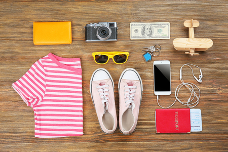 Flat lay of traveller's outfit on wooden backgroundの写真素材